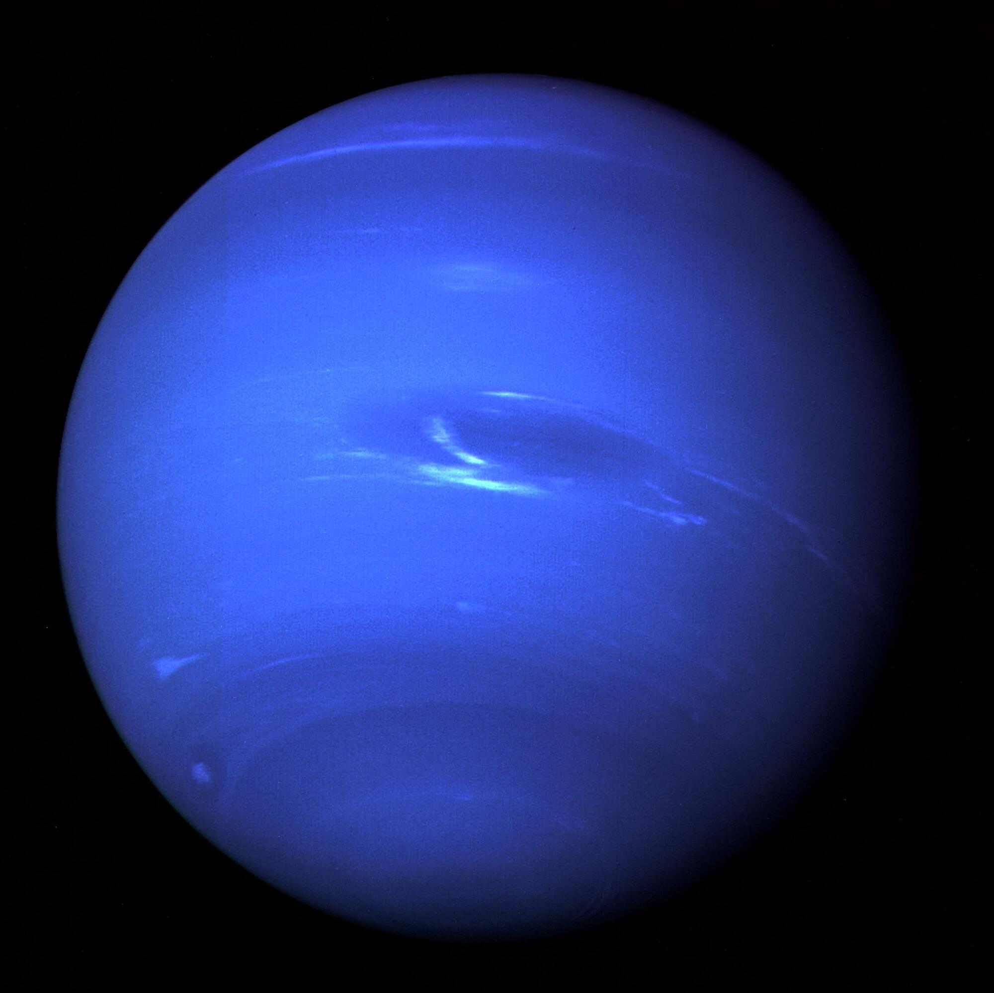 This vivid image of Neptune was beamed back to Earth in 1998 by NASA's Voyager 2 spacecraft, showcasing the planet's Great Dark Spot, which has since dissipated.
